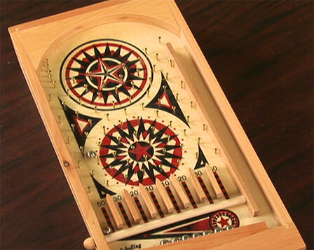 Photo of an old-fashioned, wooden pinball game.