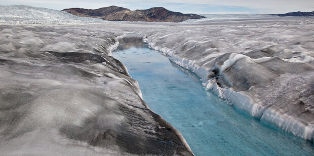 Photo of dirty ice surrounding a meltwater stream near the margin of the ice sheet.