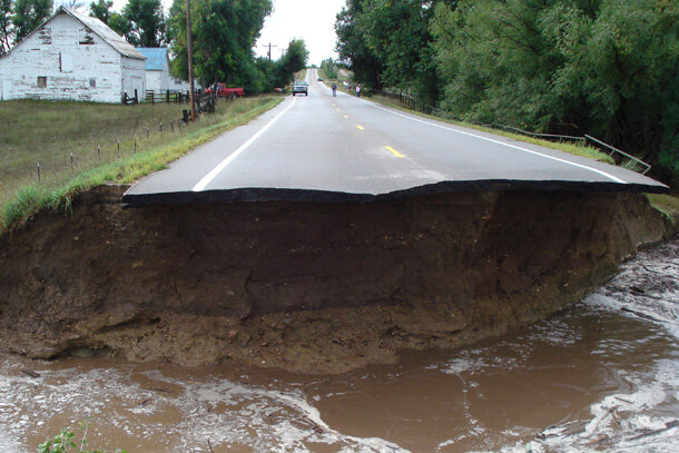 Photo depicting a county road washed out by flash flooding near Berthoud, Colorado, in September 2013