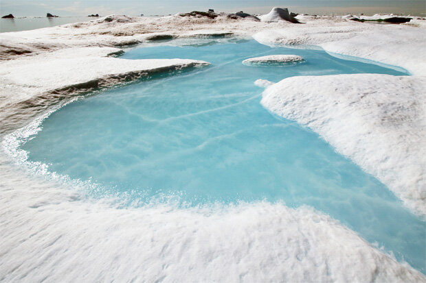 Photo of a meltwater pond on an iceberg in Northwest Greenland in 2011.