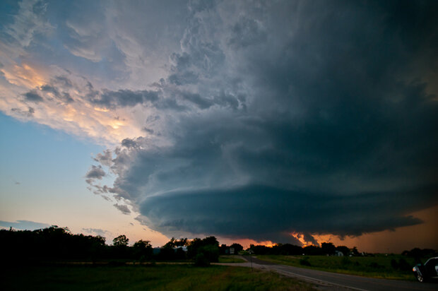 Photo of a supercell thunderstorm and a tornado