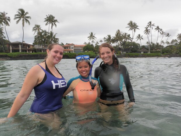 Photo of La Valle and two female undergraduate students standing in water near shore 