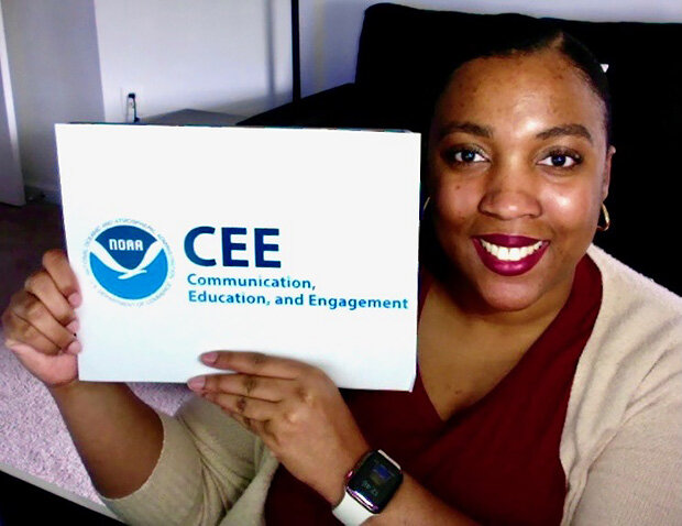 Shae Green holding a CEE sign