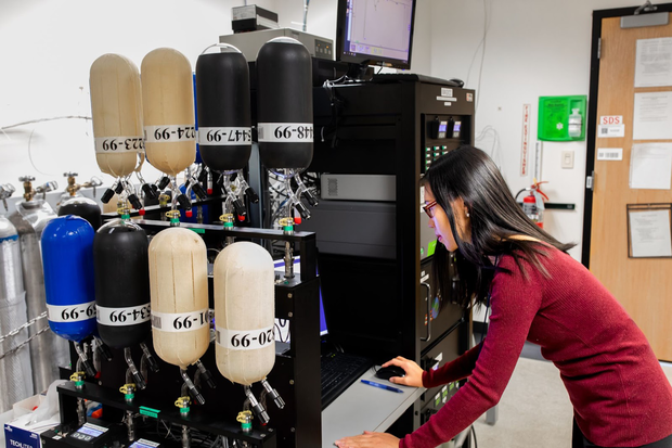 Air flasks attached to an instrument with a person at the computer controls