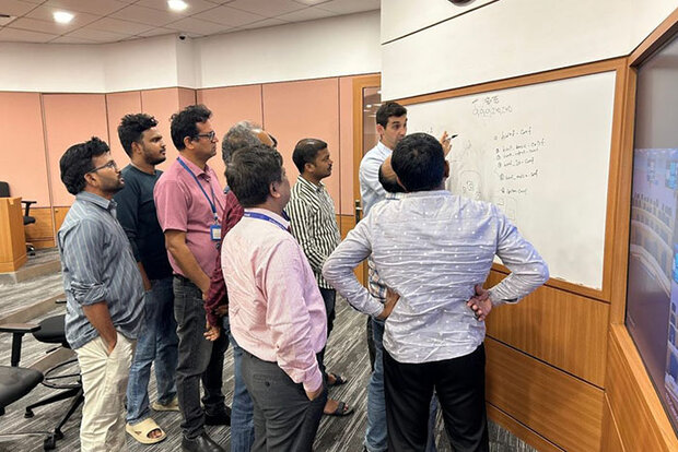 Researchers in front of white board