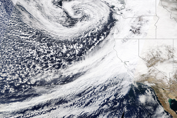 Natural-color satellite image of a long plume of cloud reaching from the tropics to the U.S. West Coast