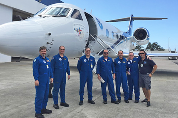 Flight crew standing on tarmac in front of airplane