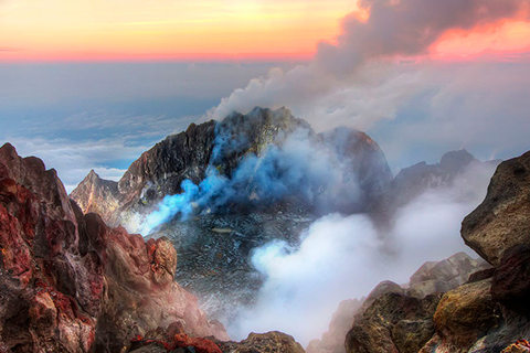 Which emits more carbon dioxide: volcanoes or human activities?
